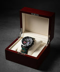The black watch with the colorful camouflage-style dial and strap)